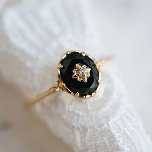Goldener Ring mit schwarzem Onyx und Diamant, elegantes Schmuckstück für Damen.